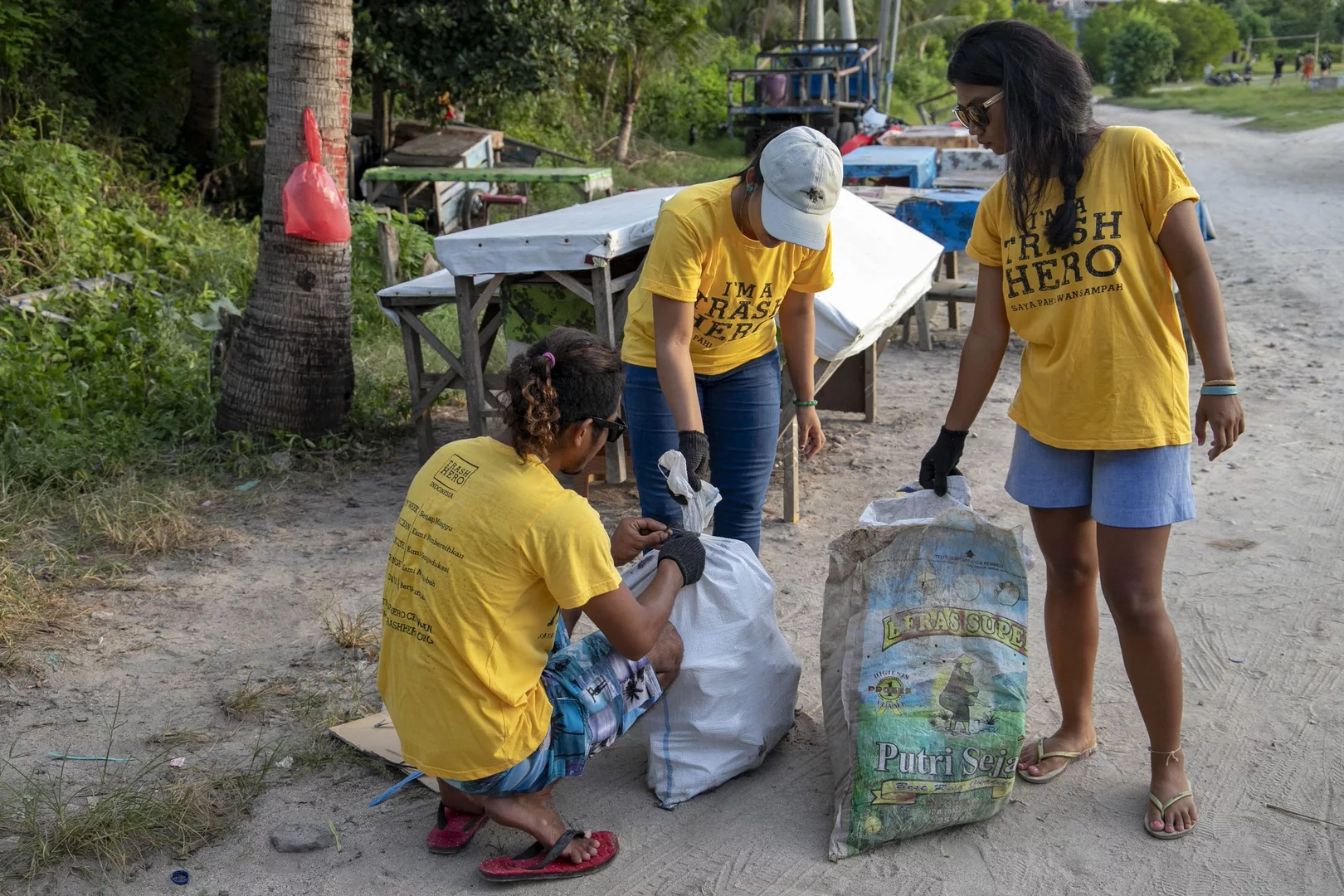Staff of Ceningan Divers clean up rubbish above the water